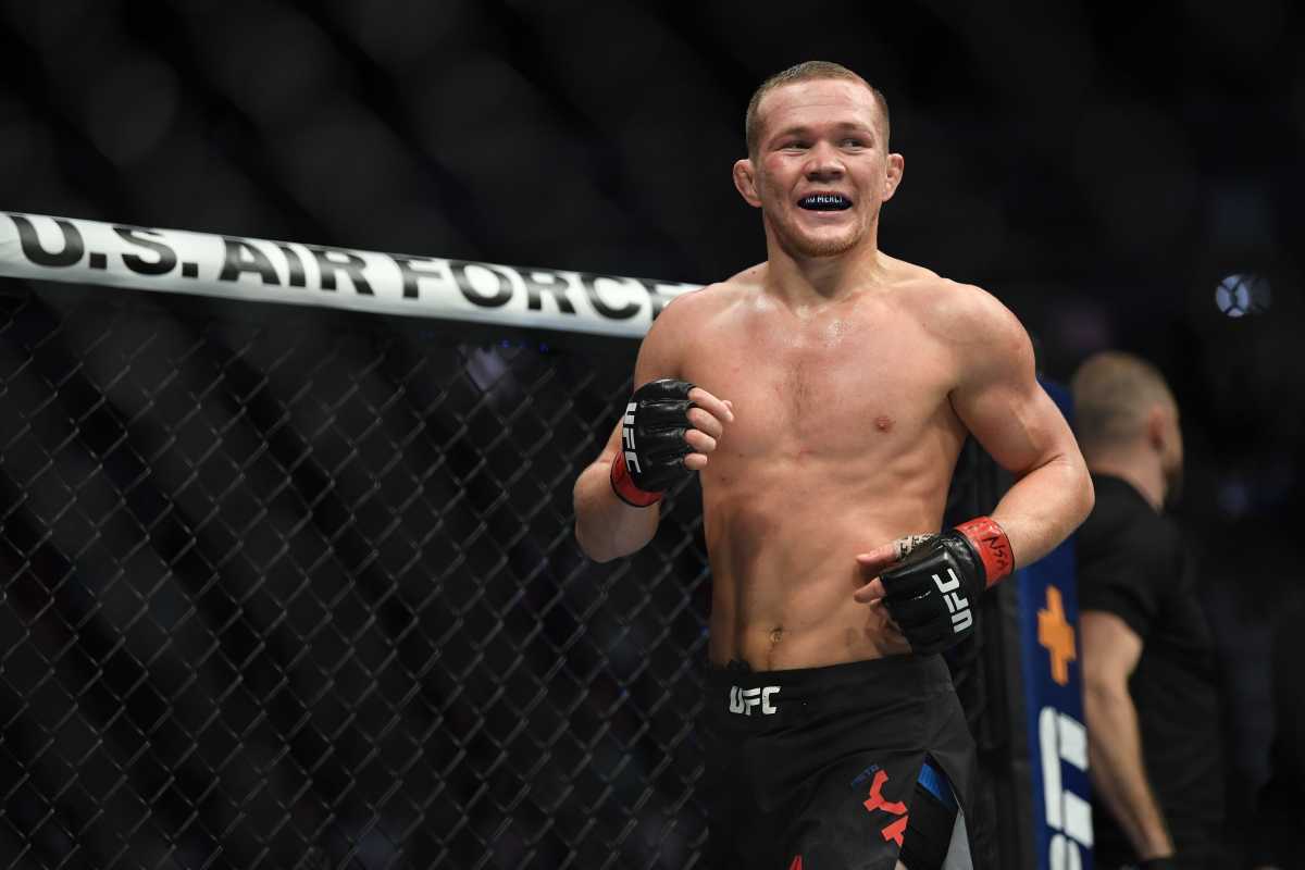 Petr Yan (red gloves) reacts after defeating Urijah Faber (not pictured) during UFC 245 at T-Mobile Arena.